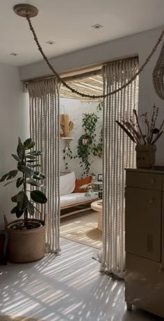 a living room filled with lots of furniture and plants