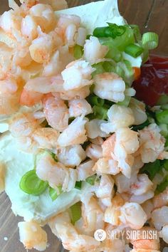 a salad with shrimp and lettuce on it