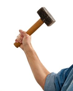 a man holding a hammer in his right hand