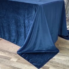 a blue table cloth on top of a wooden floor