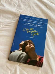 the book called call me by your name is laying on a bed