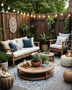 an outdoor living room with wooden furniture and potted plants on the table, surrounded by string lights