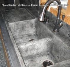 a concrete sink with two faucets in it