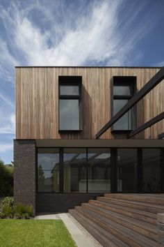 the house is made out of wood and has stairs leading up to it