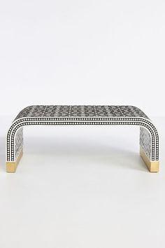 a black and white bench sitting on top of a table