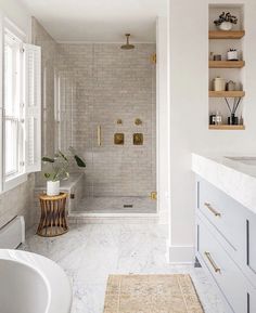 a bath room with a tub a sink and a window