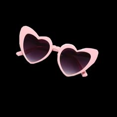 pink heart shaped sunglasses on a black background