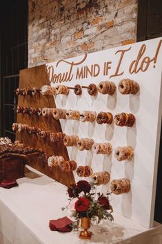 doughnuts are arranged on a display in front of a sign that says donut mind if i do