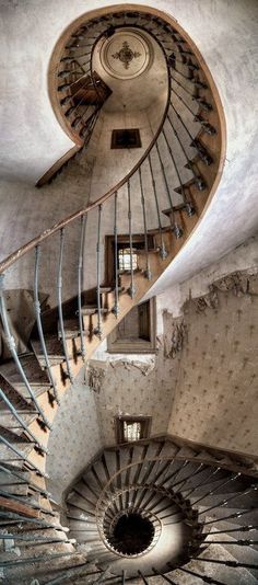 a spiral staircase in an abandoned building