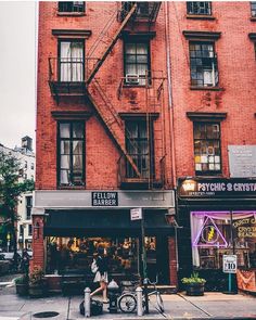 a person sitting on a bench in front of a building