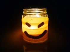 a lit candle with a smiley face drawn on it