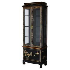 an antique black and gold china cabinet with glass doors