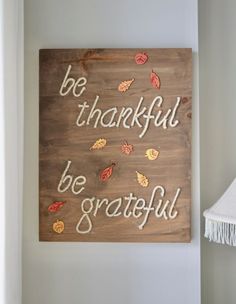 a wooden sign that says, be grateful