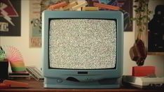 an old tv sitting on top of a wooden table