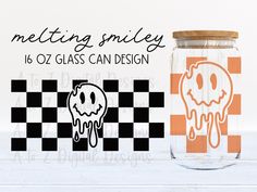 a glass jar with a ghost on it next to an orange and black checkerboard background