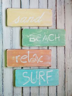 three wooden signs that say sand, beach, relax and surf on white wood planks