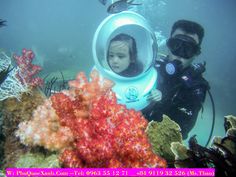 a man and child in scuba gear on the ocean floor with corals under water