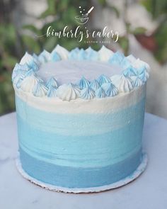 a blue and white cake sitting on top of a table