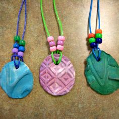 three necklaces with different colored beads on them