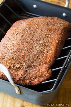 a large piece of meat sitting on top of a grill