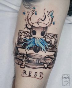 an artistic tattoo design on the leg of a woman's arm with a skull and blue flowers