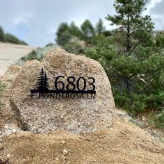 a large rock with a sign on it that reads 6303 ponderosatann