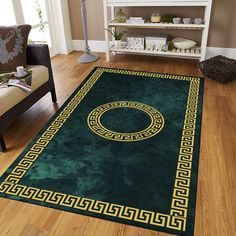 a green area rug with a gold greek border on the floor in a living room