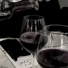 two wine glasses sitting on top of a table