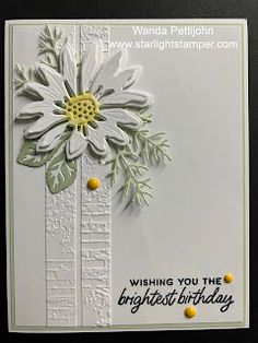 a white card with yellow and green flowers on it