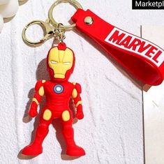 an iron man keychain is shown on a towel with a name tag attached to it