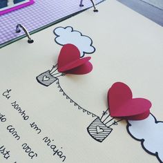 two paper hearts are attached to a bulletin board