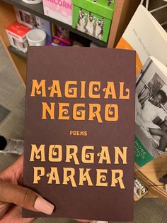 a person holding up a book about morgan parker