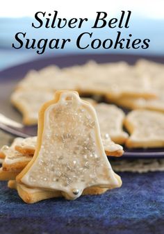 silver bell sugar cookies on a plate with the words, silver bell sugar cookies above them