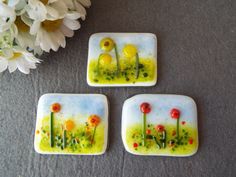 three small plates with flowers painted on them