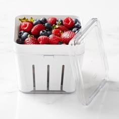 a white container filled with berries and blueberries