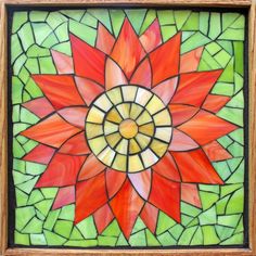 a stained glass window with a red flower on it