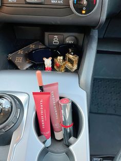 the interior of a car with various items in it, including lip balm and lipstick