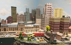 a model city with buildings and cars on display