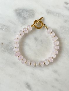 Rose Quartz rondelle beaded bracelet with gold miyuki spacer beads and IP gold plated toggle clasp Rose quartz properties: * love * friendship * balance * Please note that due to the fact these are natural gemstones the colours may vary with each bracelet. Keep away from water. Avoid direct contact with perfumes and chemicals. Remove before showering or swimming. Everyday Beaded Rose Quartz Bracelets, Gold Rose Quartz Beaded Bracelets, Gold Rose Quartz Beaded Bracelets With Round Beads, Gold Beaded Bracelets With Rose Quartz Round Beads, Gold Beaded Bracelets With Rose Quartz, Gold Beaded Bracelet With Rose Quartz Round Beads, Rose Quartz Properties, Quartz Properties, Rose Bracelet