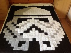 a black and white quilt on top of a bed