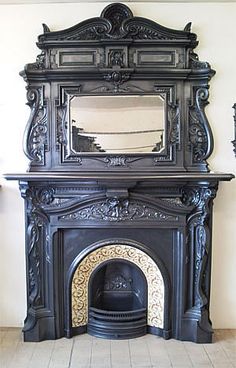 an ornate fireplace with a mirror above it