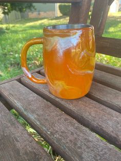 a glass mug sitting on top of a wooden bench