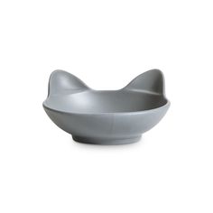 a white bowl with a cat's head on the top and bottom, sitting in front of a white background