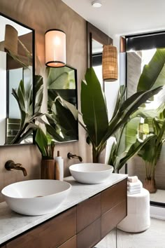 a bathroom with two sinks, mirrors and large plants in the middle of the room