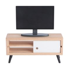 a computer monitor sitting on top of a wooden shelf next to a white and black keyboard