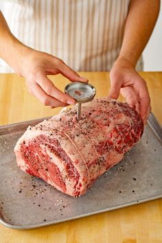 a person using a meat grinder on top of a piece of meat