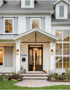 a white house with lots of windows on the front door and steps leading up to it