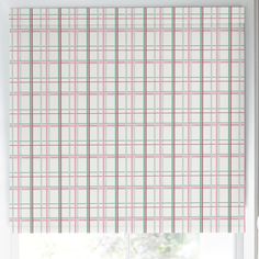 a window with a pink and green checkered roman blind in front of the window