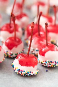 candy apples with sprinkles and cherries on them are ready to be eaten