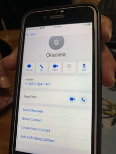 someone is holding up their cell phone with the text gracela on it's screen